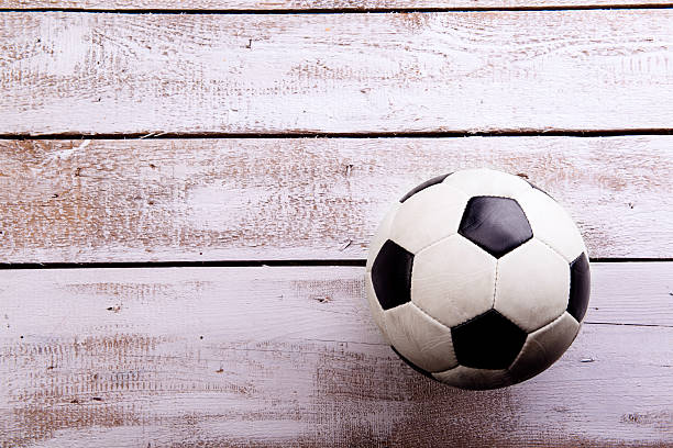 istock Soccer ball against wooden background. Studio shot. Copy space. 544810786