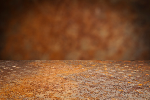 Empty rusty metal table with defocused vertical background. Ideal for product display on top of the table.