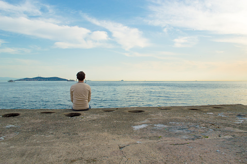 Young Man Sitting by the Sea