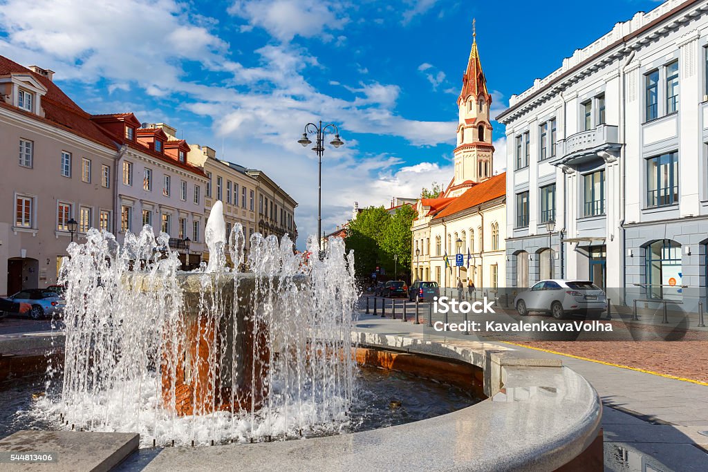 Fountain and church, Old town Vilnius, Lithuania. Fountain and church in the old city summer sunny day, Vilnius, Lithuania, Baltic states. Architecture Stock Photo
