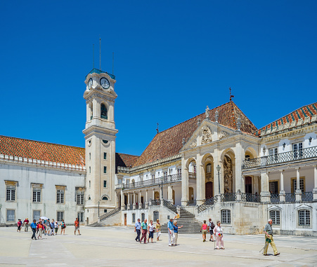 Coimbra, Portugal - June 21, 2016. Tourists crossing Patio das Escolas courtyard of the Coimbra University. Portugal.