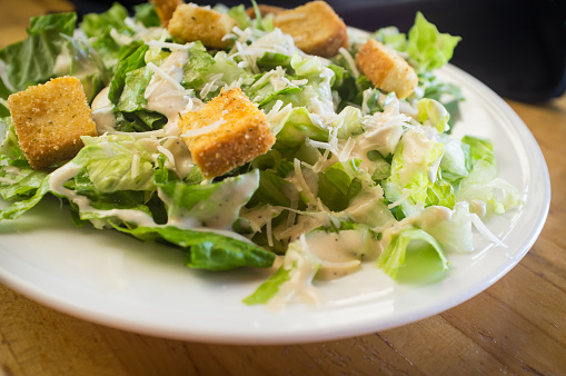 Fresh organic caesar salad with grated asiago cheese