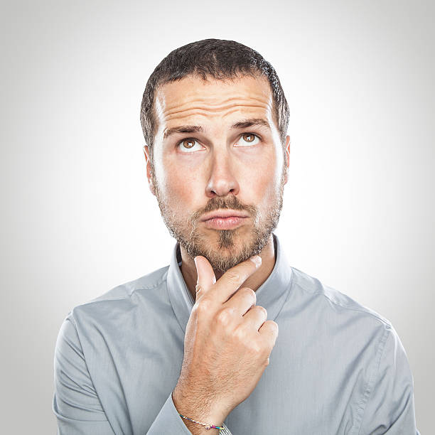 istock Portrait of handsome young thoughtful man isolated over white ba 544814350