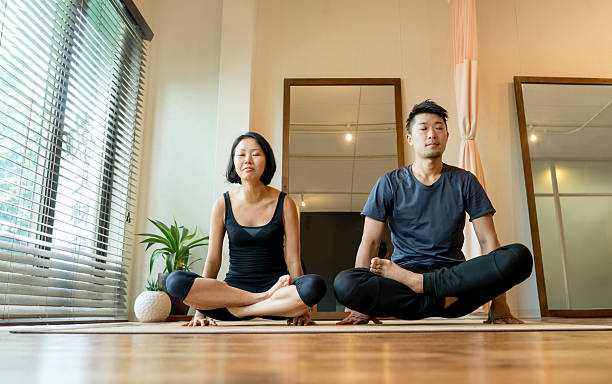 istock Couple doing yoga at home 544815592
