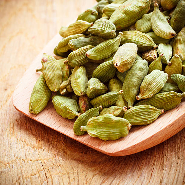 istock Green cardamom pods on wooden spoon 544817544