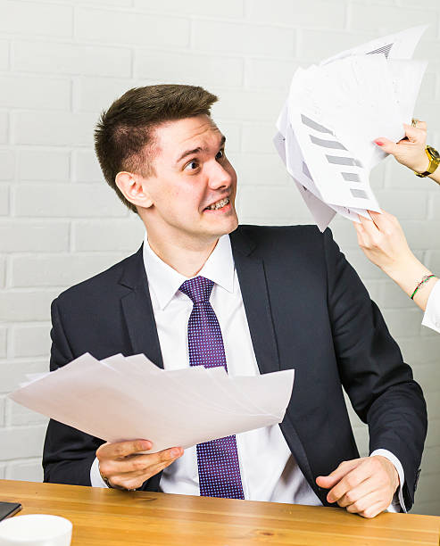 istock angry business man working at office with documents on his 544818778