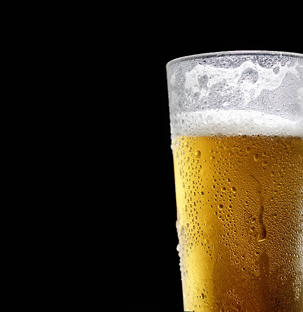 istock beer in a glass on a black background 544819006