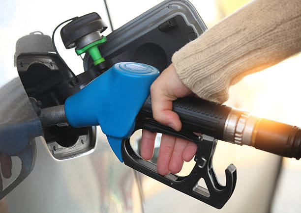istock Mans hand refilling the car with a gas pump 544819450