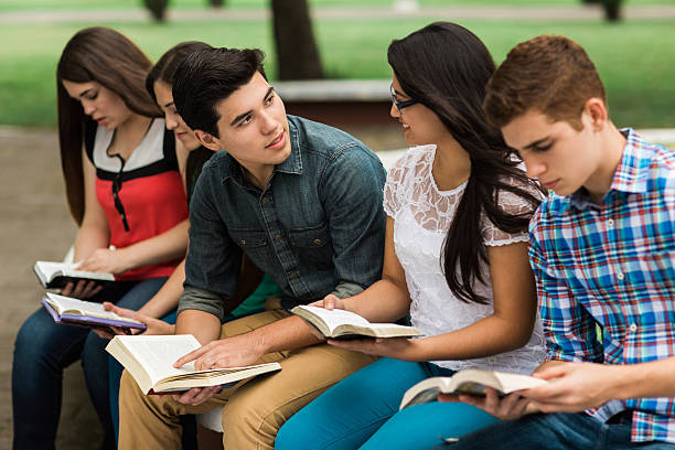 istock Young man holding book and facing young woman 544819574