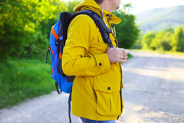 istock Side view of young man with backpack hiking 544819628