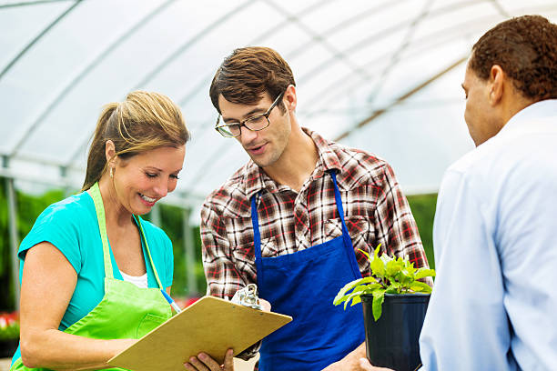 istock Garden center employees writing up a purchse for a customer 544821688