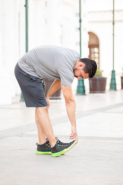 istock Runner warming up and stretching outdoors 544958284