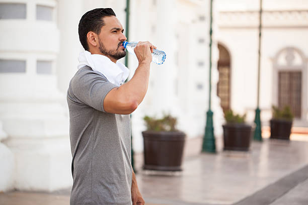 istock Young man drinking water outdoors 544959160