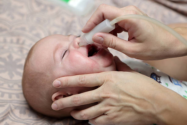 istock Mother using baby's nasal aspirator 544960444