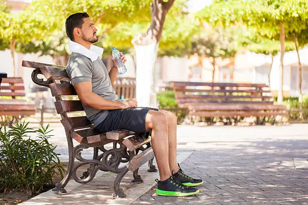 Photo of Man in sporty outfit drinking some water