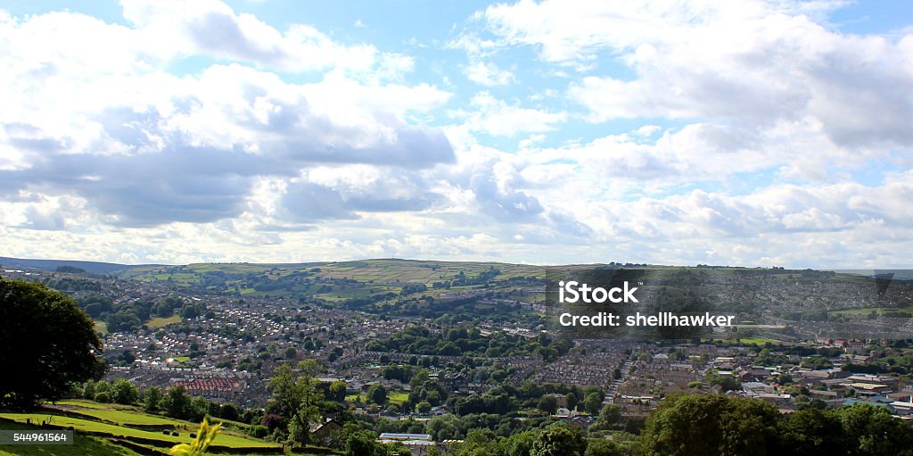 View of suburbs, Aire Valley in Keighley, West Yorkshire Photo showing the view across the Aire Valley, in the hilly Pennines, near Keighley and Bradford, towards Haworth, Bronte Country, and Skipton and the Yorkshire Dales, taken in Keighley on a July afternoon. Photo shows the suburbs around the small town on a sunny day from farmers fields. Taken with a Canon EOS 1200D digital SLR Camera. West Yorkshire Stock Photo