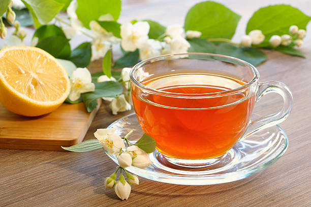 istock Tea with lemon and branches of a blooming jasmine 544963404
