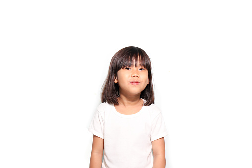 6 years Asian girl smile in white t shirt isolated on white background
