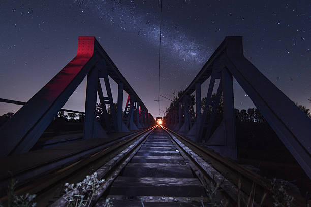 istock Railway bridge during night with MilkyWay galaxy - stock image 544968140