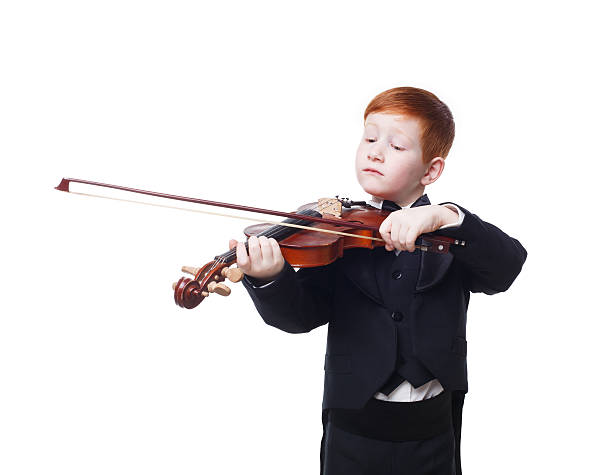 istock Cute redhead child boy plays violin isolated at white background 544971726