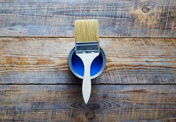 istock open jar with blue paint and red brush top view 544972198