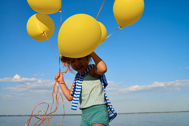istock Cheerful girl with balloons 544972822