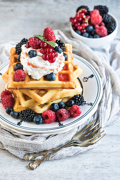 Belgium waffles with berry fruits and ice cream on top,selective focus