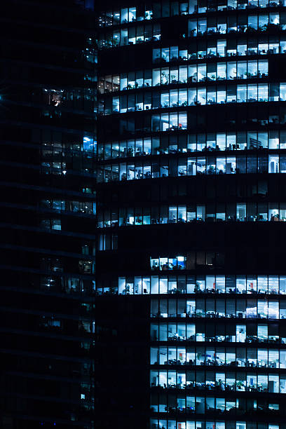 istock Windows of business office in tall building, night 544972908