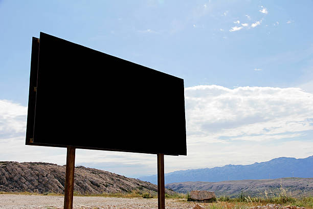 istock large, black, empty advertising sign in the countryside 544973162