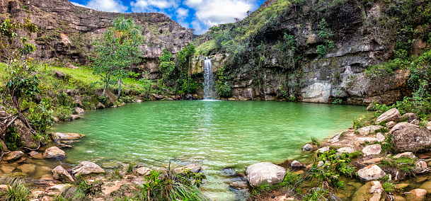 Oasis or Quebrada Pacheco waterfall (Pacheco Creek). La Gran Sabana Venezuela. This paradisaical and famous place, like an oasis, is located near the main road crossing La Gran Sabana. The savanna, or La Gran Sabana, spreads into the regions of the Guiana Highlands and south-east into Bolívar State all the way to the borders with Brazil and Guyana. The Gran Sabana has an area of 10,820 km2 and is part of the second largest National Park in Venezuela, the Canaima National Park. The largest National Park in Venezuela is Parima Tapirapecó located in the Amazon State. The average temperature is around 20 °C , but at night can drop to 13 °C, nevertheless on top of the tepuis it can reach 0 °C (32 °F). La Gran Sabana shows one of the most unusual landscapes in the world, with rivers, waterfalls, deep and huge valleys, impenetrable jungles and savannahs that host large numbers and varieties of plant and animal species. The most prominent geological features are the table top mountains known as tepuis.