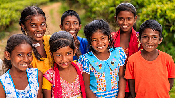 Sri Lankan young children near Nuwara Eliya, Ceylon Sri Lankan young children posing on a tea plantaion. Their parents work on this tea plantattion near Nuwara Eliya, Ceylon. Sri Lanka (Ceylon) is the world's fourth largest producer of tea and the industry is one of the country's main sources of foreign exchange and a significant source of income for laborers. nuwara eliya stock pictures, royalty-free photos & images