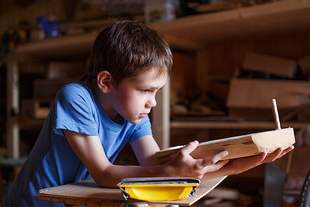 istock child makes a wooden ship 544974130