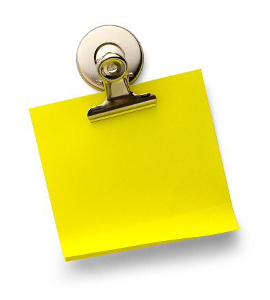 Yellow Sticky Note with Magnetic Metal Paper Clip Isolated on a White Background.