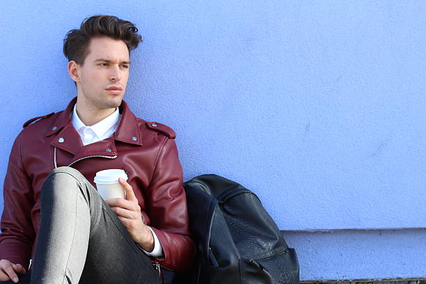 istock Man sitting outdoors with cup of coffee 544975436
