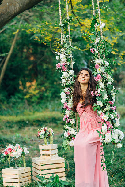 istock Beautiful young girl on a swing 544975710