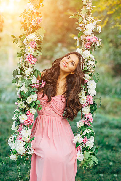 Beautiful young girl on a swing