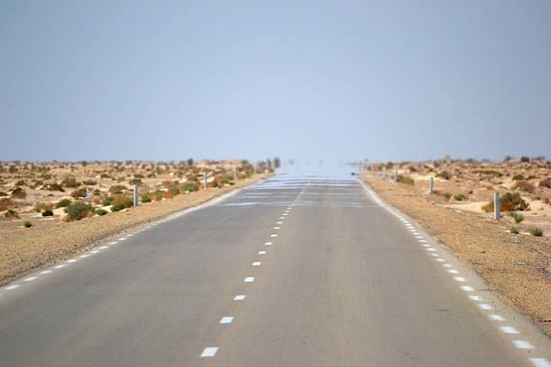 Desert mirage on road Mirage on desert in Tunisia, North Africa. heat haze stock pictures, royalty-free photos & images