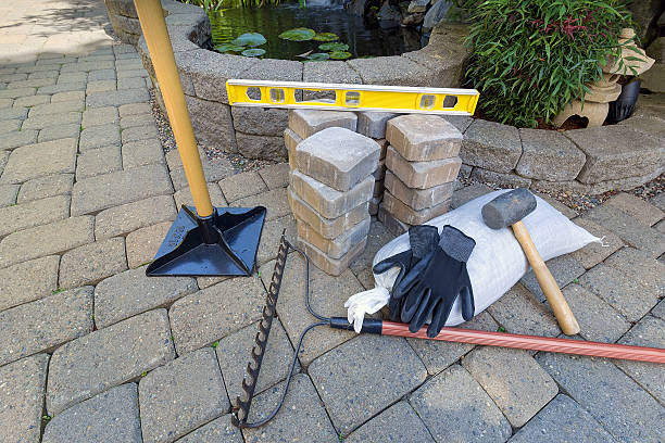 stone brick pavers with garden tools - tamper imagens e fotografias de stock