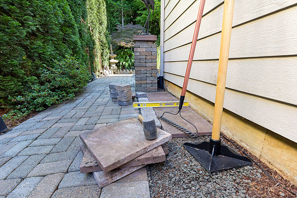 Stone Pavers and Tools for Side Yard House Landscaping Stone Pavers and tiles for side yard patio hardscape for  garden landscaping tools rubber mallet sand gravel tamper level rake hardscape photos stock pictures, royalty-free photos & images