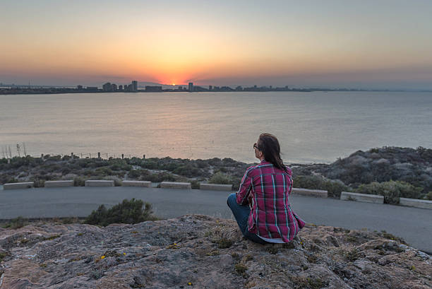 Woman watching sunset. Mediterranean, Spain. June 03, 2016.