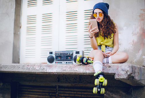Hip hop style female with boom box radio and roller skates