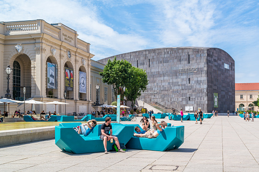 Vienna, Austria - May 23, 2016: Museums Quartier square with people and modern art museum MUMOK in Vienna, Austria