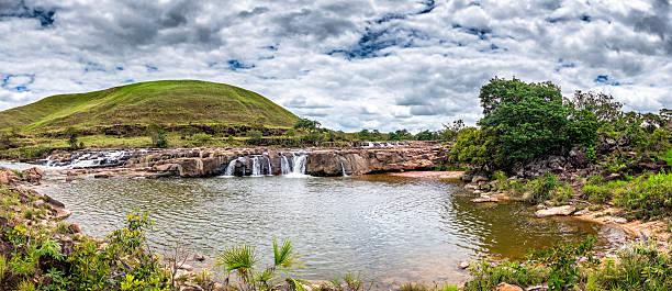 Panoramic view Sorowöpo pond (Soroape), La Gran Sabana, Venezuela Panoramic view of Balneario de Sorowöpo (Soroape). KM 244, La Gran Sabana, Venezuela. The savanna, or La Gran Sabana, spreads into the regions of the Guiana Highlands and south-east into Bolívar State all the way to the borders with Brazil and Guyana. The Gran Sabana has an area of 10,820 km2 and is part of the second largest National Park in Venezuela, the Canaima National Park. The largest National Park in Venezuela is Parima Tapirapecó located in the Amazon State. The average temperature is around 20 °C , but at night can drop to 13 °C, nevertheless on top of the tepuis it can reach 0 °C (32 °F). La Gran Sabana shows one of the most unusual landscapes in the world, with rivers, waterfalls, deep and huge valleys, impenetrable jungles and savannahs that host large numbers and varieties of plant and animal species. The most prominent geological features are the table top mountains known as tepuis. guyana photos stock pictures, royalty-free photos & images