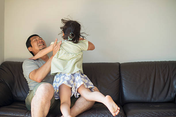 istock Father and daughter playing together at home 544978262