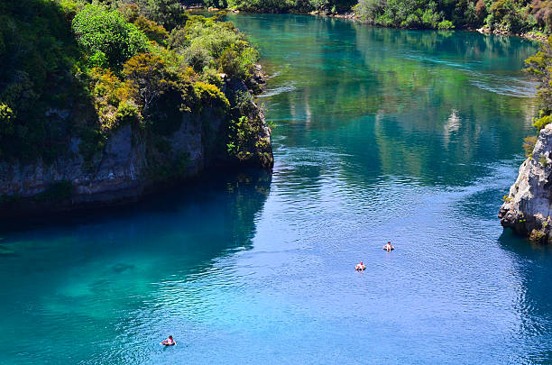 Aerial view of the Waikato River near Taupo, New Zealand Taupo, New Zealand - January 14, 2016: Aerial view of people floating on tubes over the Waikato River near Taupo. It's the longest river in New Zealand, running for 425 kilometres (264 mi) through the North Island. waikato river stock pictures, royalty-free photos & images
