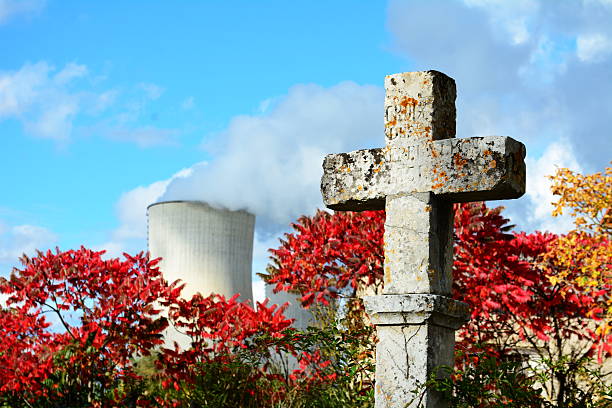 istock Old stone cross with nuclear power plant in background 544979342