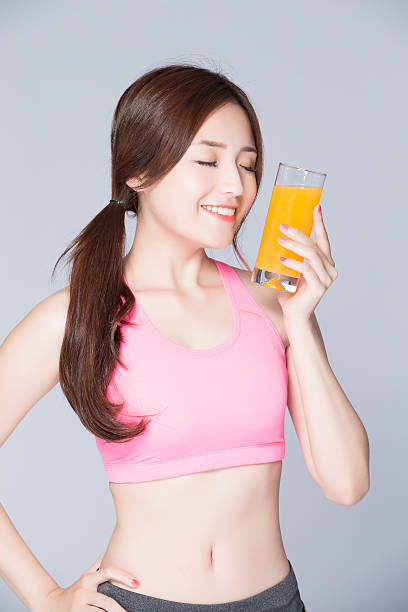 istock young girl drink orange juice 544981548