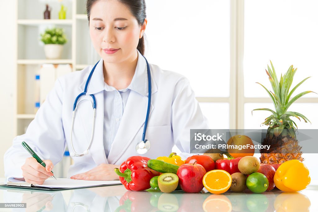 Doctor nutritionist with fruits and vegetable Doctor nutritionist with fruits and vegetable, health eating Nutritionist Stock Photo