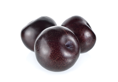 ripe black plum on white background