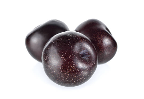 ripe black plum on white background ripe black plum on white background plum red white purple stock pictures, royalty-free photos & images